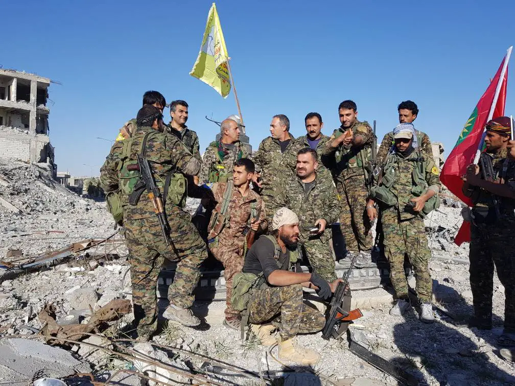 SDF and YBS fighters celebrate in Raqqa