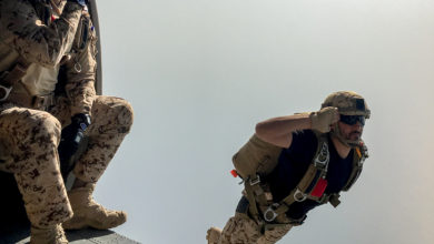 Bahrain Defense Forces paratrooper salutes as he jumps