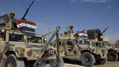Iraqi Security Forces salute from Humvees