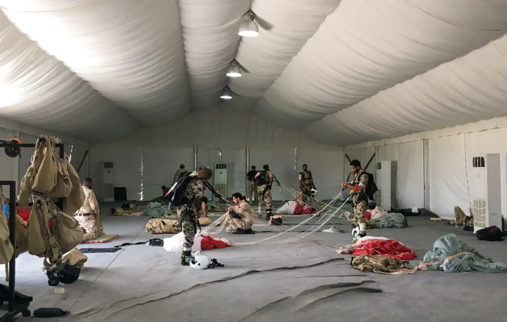 Bahrain Defence Force paratroopers prepare parachutes