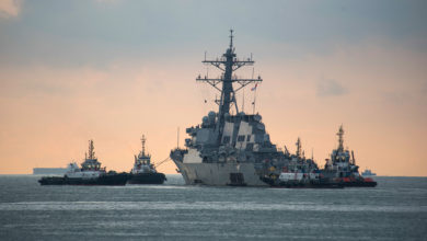 USS John S. McCain towed for transport