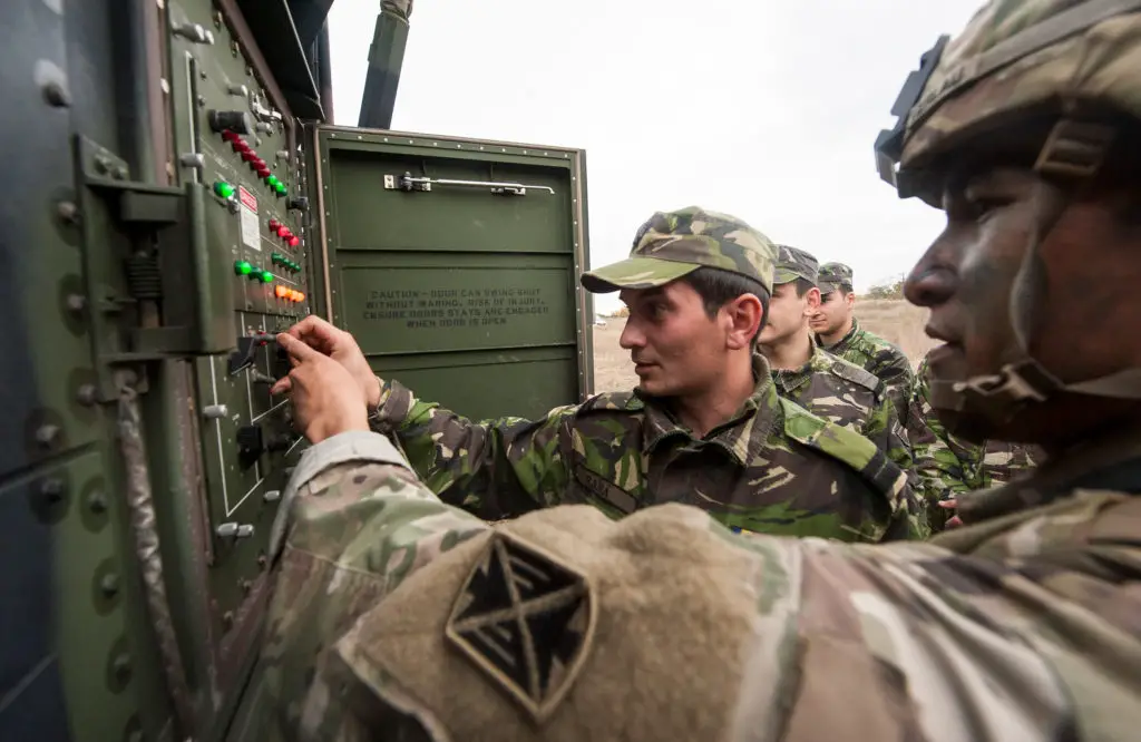 Romanian and US troops reposition a Patriot air defense missile launcher