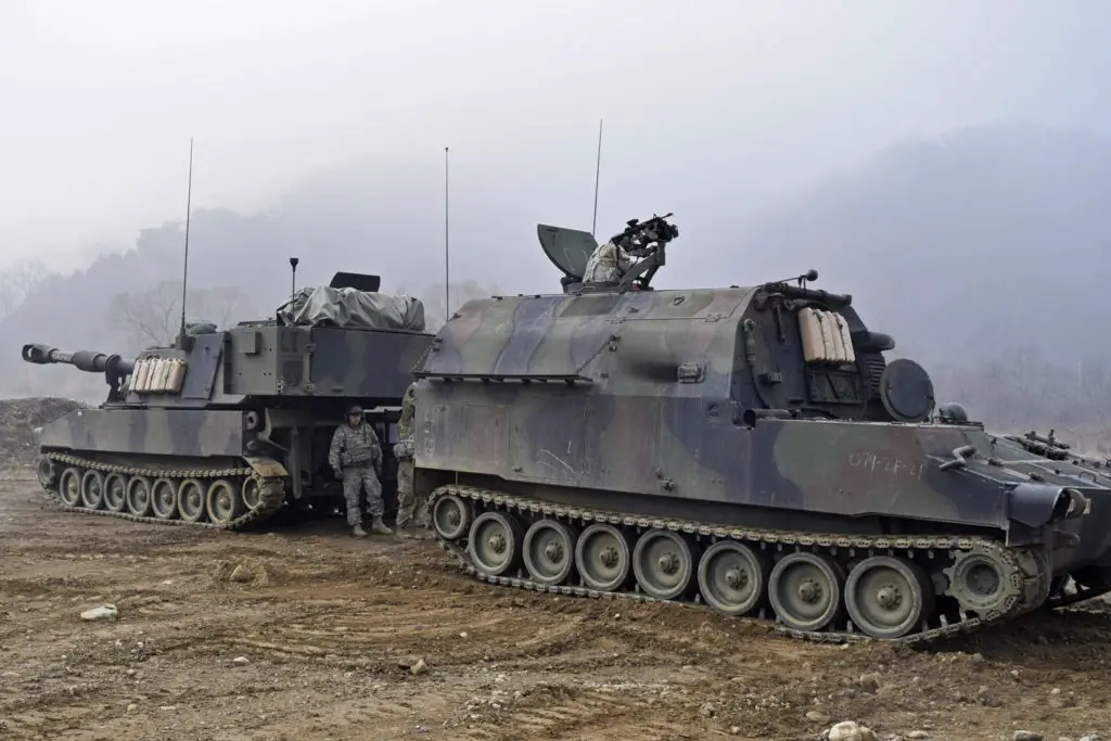 M992A2 Field Artillery Ammunition Supply Vehicle resupplies an M109A6 Paladin howitzer