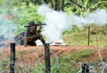 Ugandan People’s Defence Force soldier fires an RPG