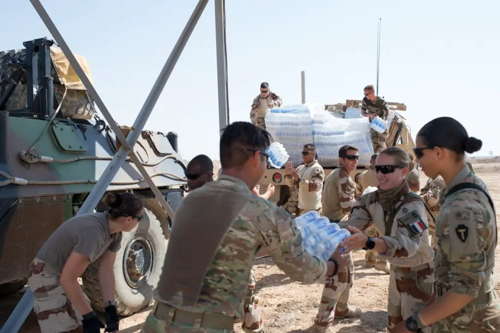 French and American forces offload supplies in Syria's Euphrates River Valley in May 2018
