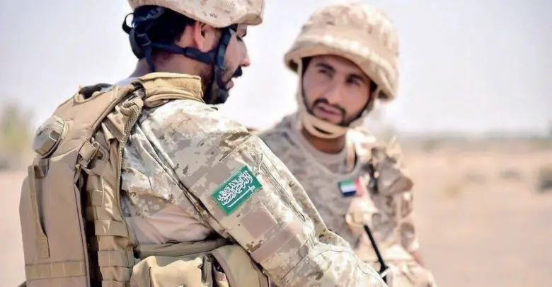 Saudi Arabia soldier talks to UAE soldier