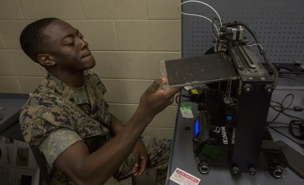 A U.S. Marine demonstrates how to use a 3d printer