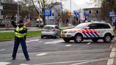 Dutch police officer regulates traffic at 2014 Nuclear Security Summit in the Netherlands