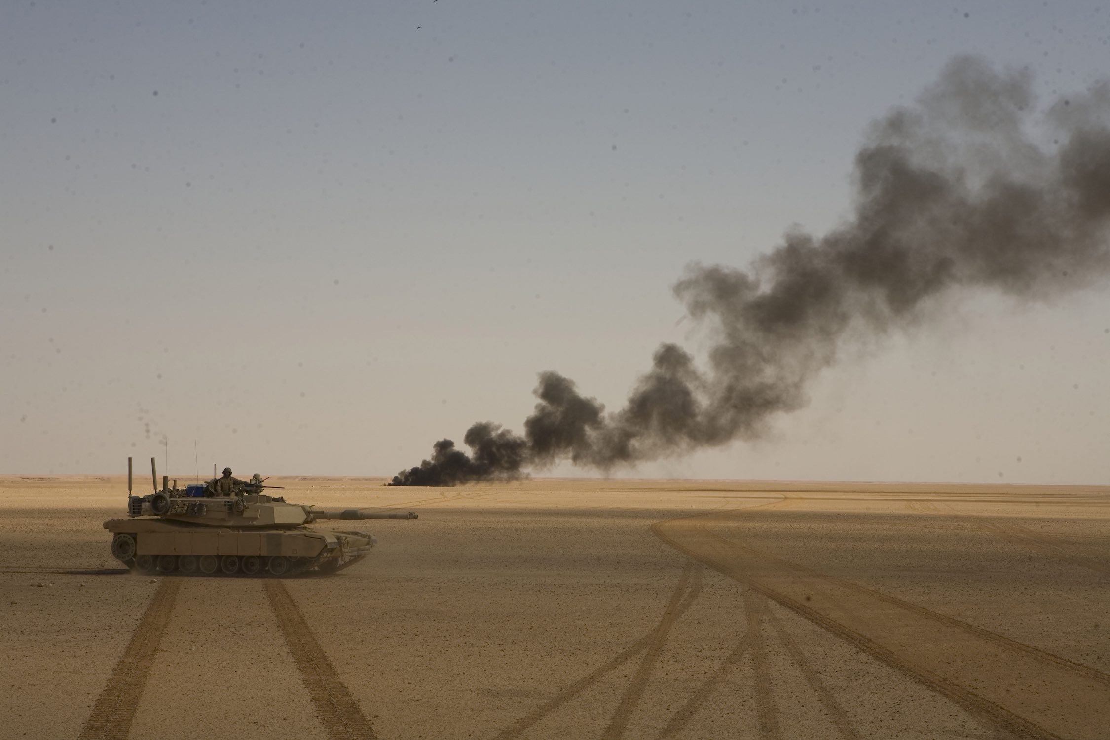 Chemical barrels are set ablaze by the Marines of 1st Tank Battalion during an operation outside Rawah, Iraq