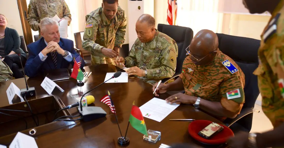 Maj. Gen. William J. Walker, Commanding General, District of Columbia National Guard and Brig. Gen. Moses Miningou the Chief of General Staff for the National Armed Forces of Burkina Faso, participate in a formal signing ceremony