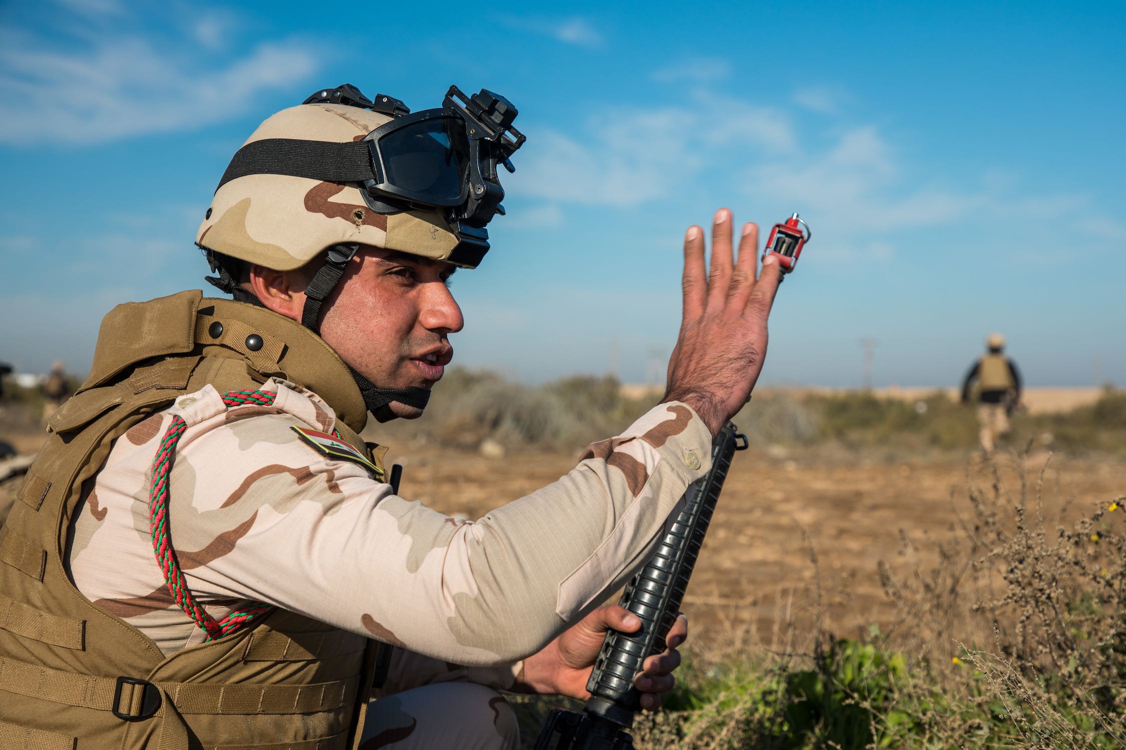 Iraqi Army soldier signals for others to move forward