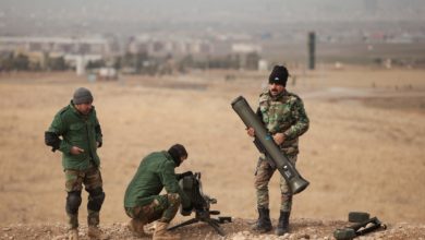 Peshmerga soldiers disassemble a Milan anti- tank missile system