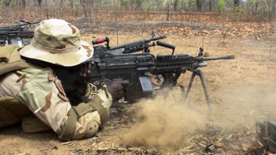 Senegal special forces soldier fires an M249 machine gun
