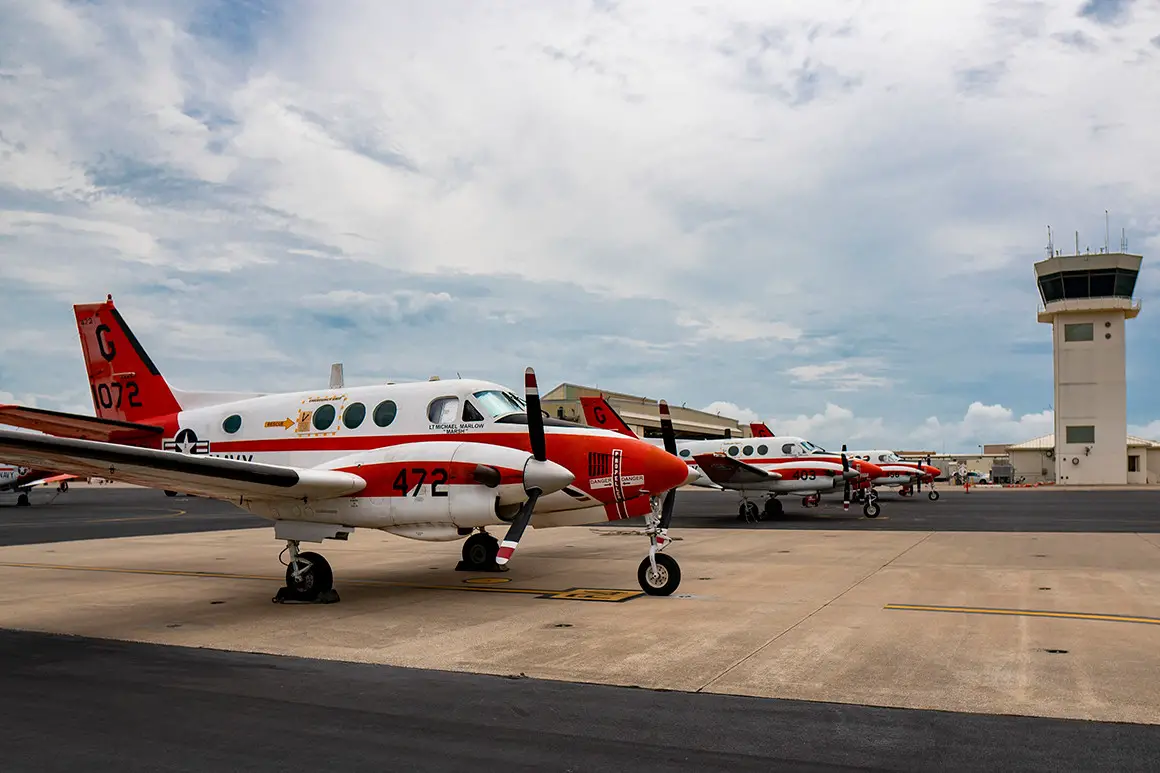 A line of Navy T-44C Pegasus' parked on the flightline aboard Naval Air Station Corpus Christi on July 23, 2019, in Texas