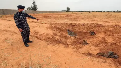 A member of security forces affiliated with the GNA's Interior Ministry surveyed the reported site of a mass grave in the town of Tarhuna, southeast of the capital Tripoli, Libya, June 2020.