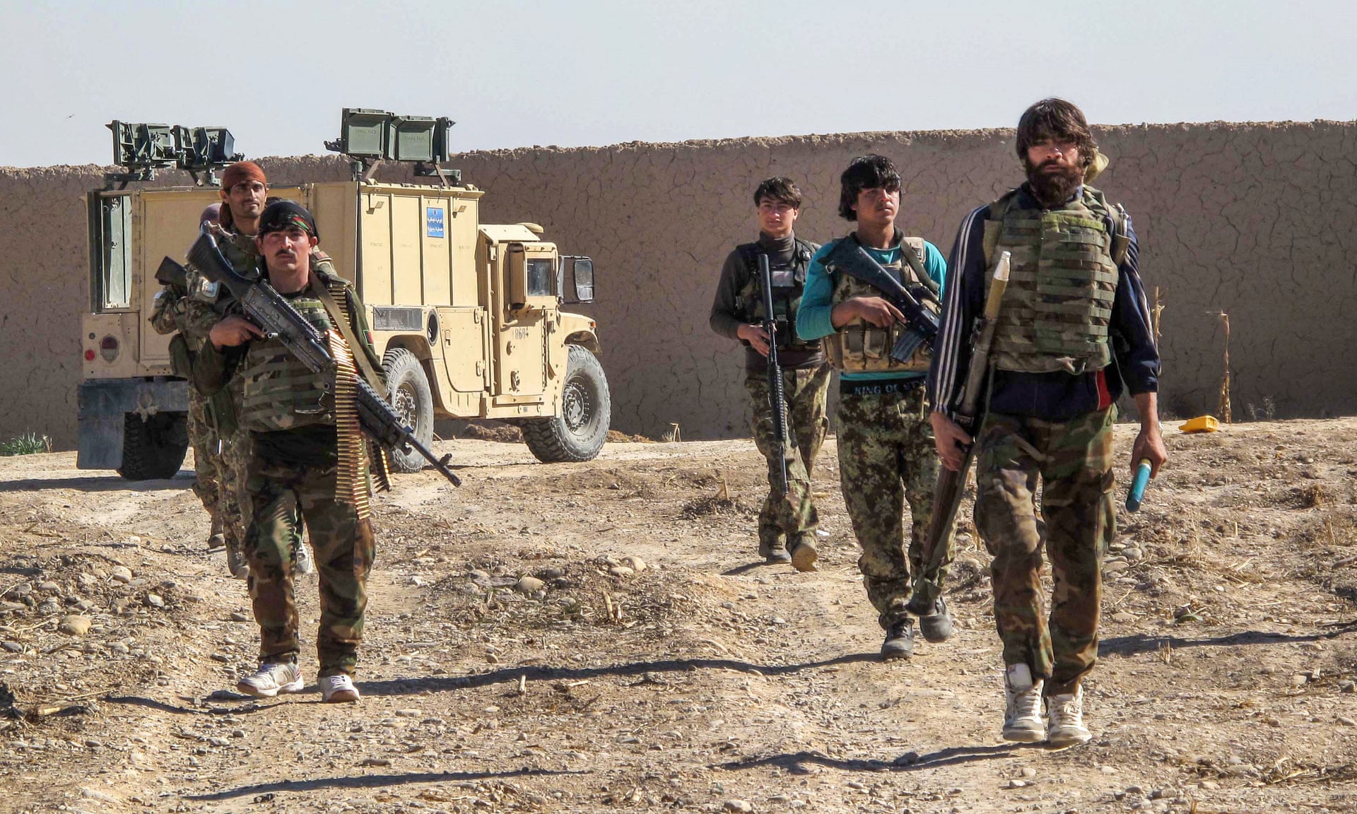Afghan soldiers patrolling an area in Helmand Province.