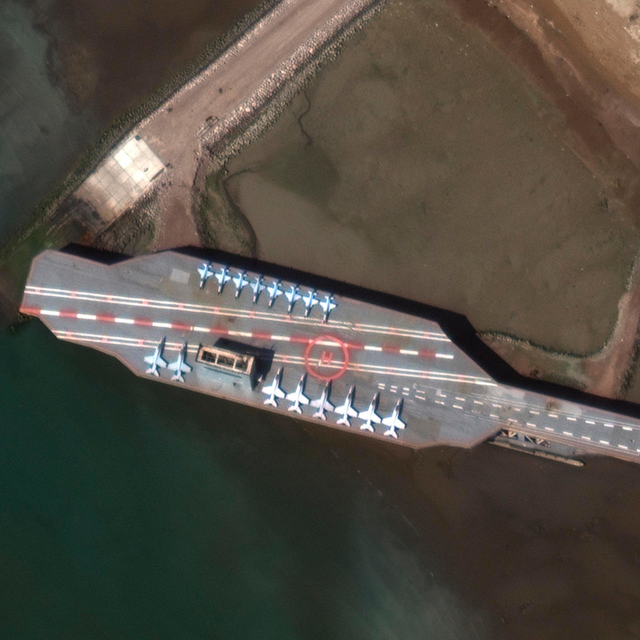 Satellite image obtained courtesy of Maxar Technologies shows a mockup aircraft carrier being prepared in the Iranian port of Bandar Abbas on February 15. Maxar Technologies/AFP