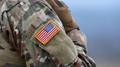 A US flag is pictured on a soldier's uniform during an artillery live fire event by the US Army Europe's 41st Field Artillery Brigade at the military training area in Grafenwoehr, southern Germany, on March 4, 2020.