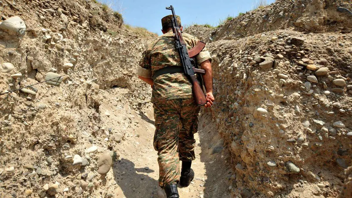 An Armenian soldier of the self-proclaimed republic of Nagorno-Karabagh walks in a trench at the frontline on the border with Azerbaijan near the town of Martakert.