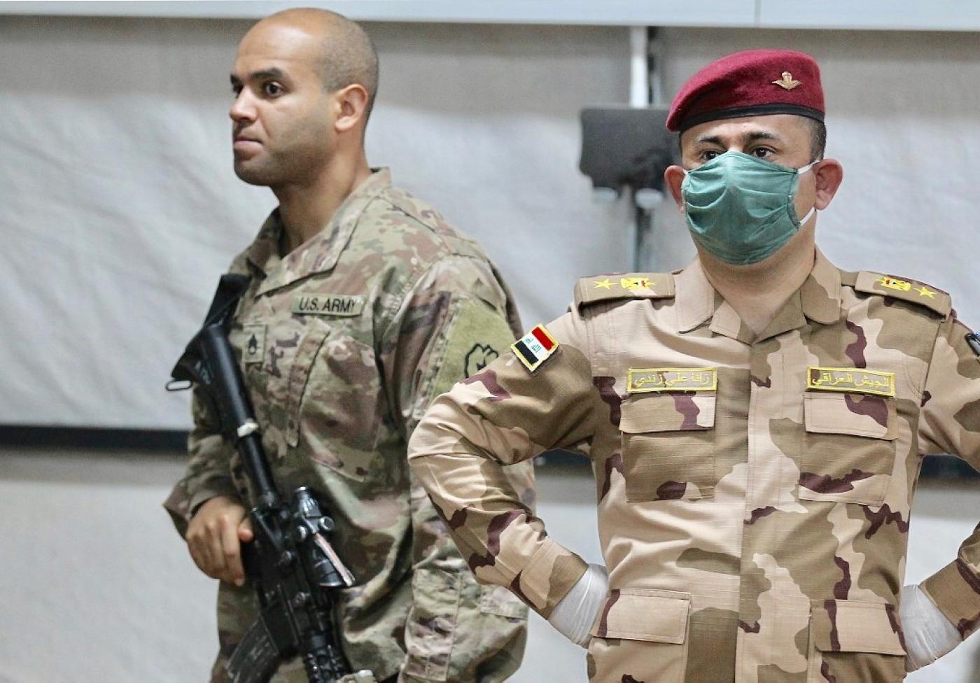 A US soldier, left, and an Iraqi army officer at Qayyarah air base in northern Iraq earlier this year