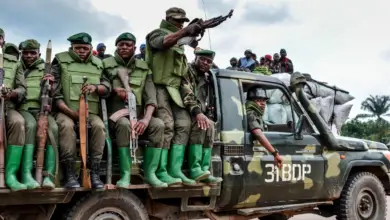 Armed soldiers of the DR Congo army on a vehicle.