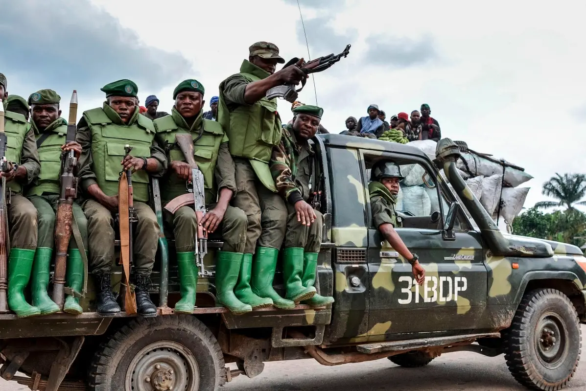 Armed soldiers of the DR Congo army on a vehicle.