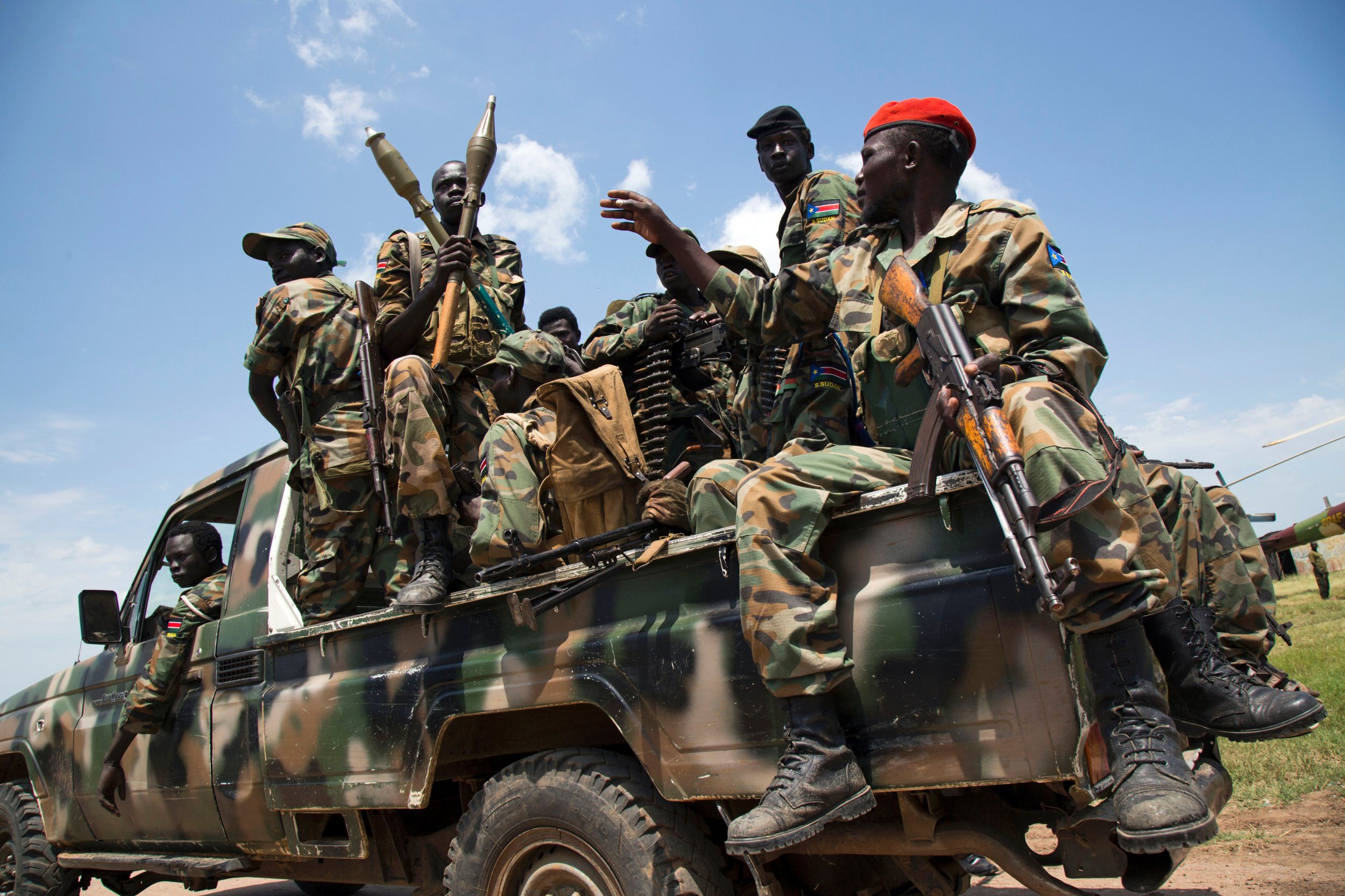 South Sudanese government soldiers sit in a pick-up truck at the military base in Malakal, northern South Sudan, on October 16, 2016.