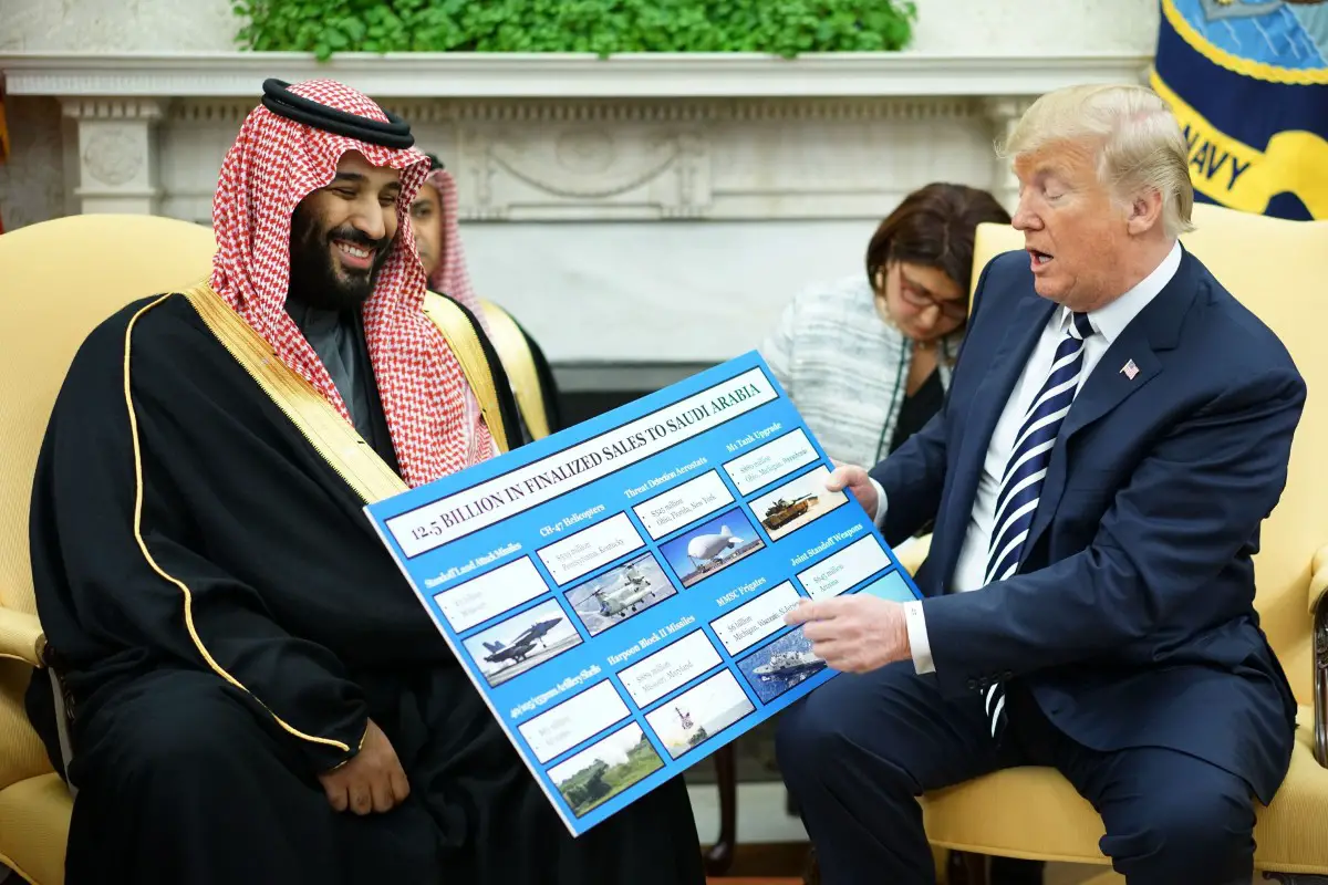 President Donald Trump shows a chart highlighting arms sales to Saudi Arabia during a meeting with Saudi Crown Prince Mohammed bin Salman in the Oval Office of the White House, Tuesday, March 20, 2018.