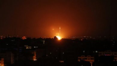 Flames are seen at a distance after Israel carried out airstrikes over Gaza.