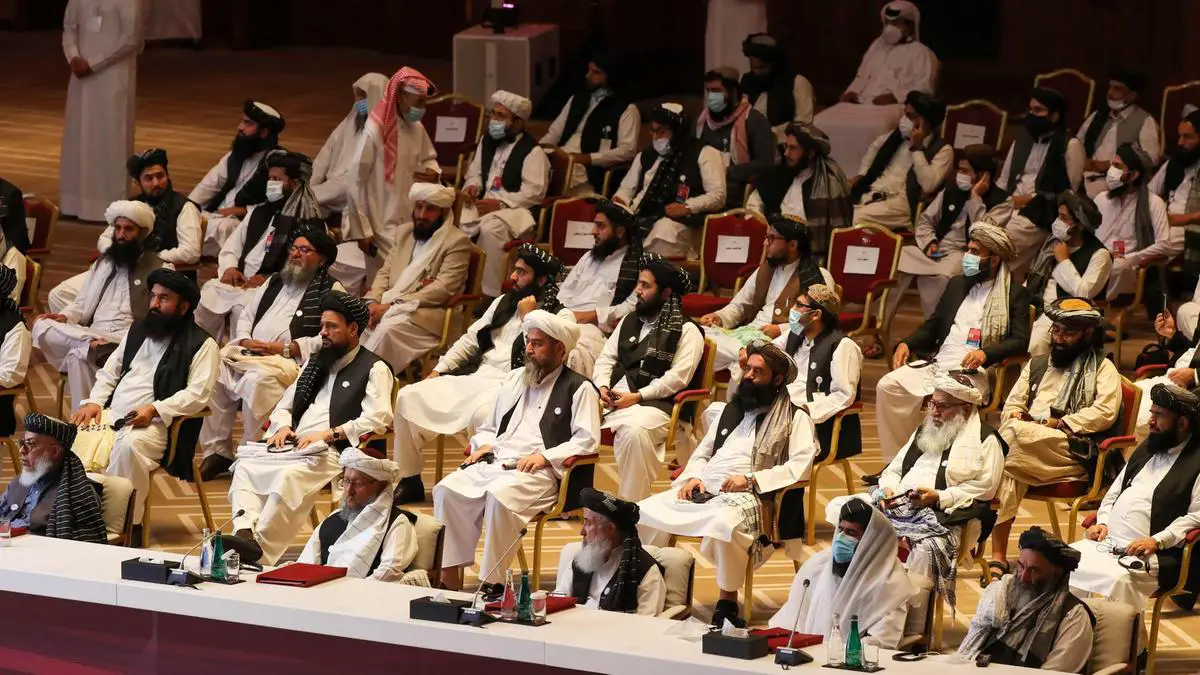 Members of the Taliban delegation attend the opening session of peace talks with the Afghan government in Doha.