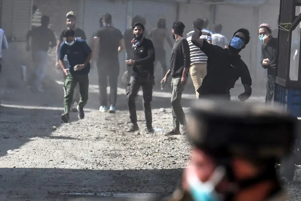 Protesters throw stones during clashes with government forces in Batamaloo area of Srinagar on September 17, 2020