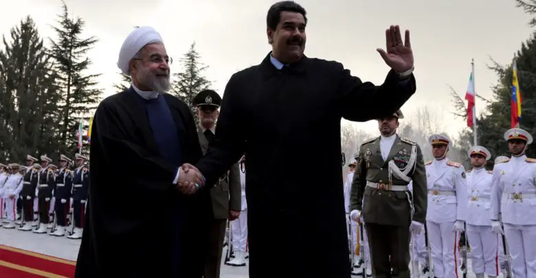 Iranian President Hassan Rouhani (left) shakes hands with Venezuelan President Nicolas Maduro after reviewing the honor guard at the Saadabad Palace in Tehran on January 10, 2015