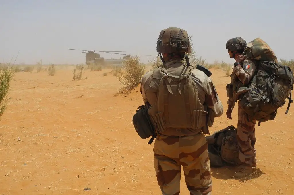 Two French soldiers wait to board a helicopter in east-central Mali.