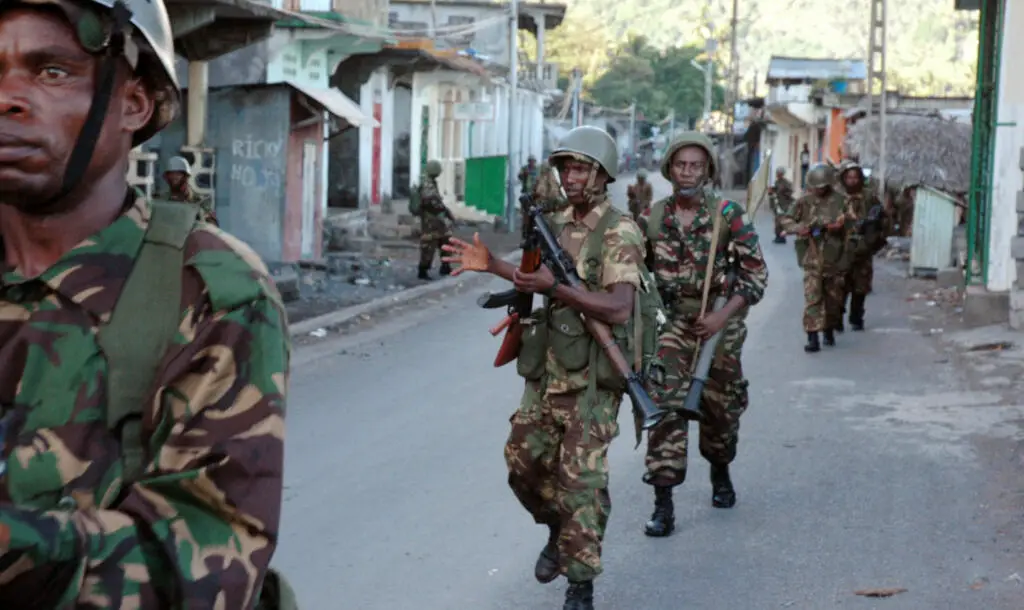 Photo of African Union troops from Tanzania and Comoran troops walking down a street in Anjouan on March 25, 2008