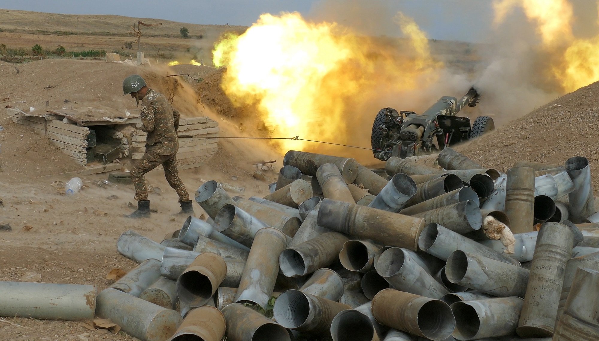 Photo of a Karabakh gunner firing an artillery piece towards Azeri positions.