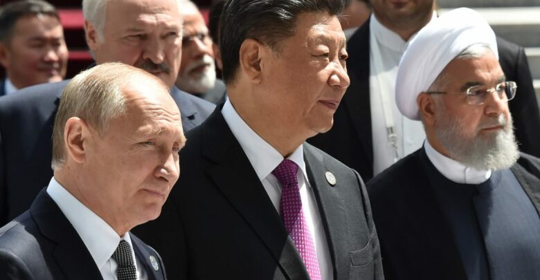 Russian President Vladimir Putin, Chinese President Xi Jinping and Iran's President Hassan Rouhani walk as they attend a meeting of the Shanghai Cooperation Organization (SCO) Council of Heads of State in Bishkek on June 14, 2019.