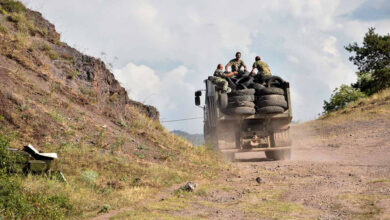 Armenian servicemen transport used tires in the back of a truck to fortify their positions on the Armenian-Azerbaijani border near the village of Movses on July 15, 2020