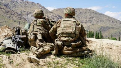 In this file photo taken on June 6, 2019 US soldiers look out over hillsides during a visit of the commander of US and NATO forces in Afghanistan General at the Afghan National Army (ANA) checkpoint in Nerkh district of Wardak province.