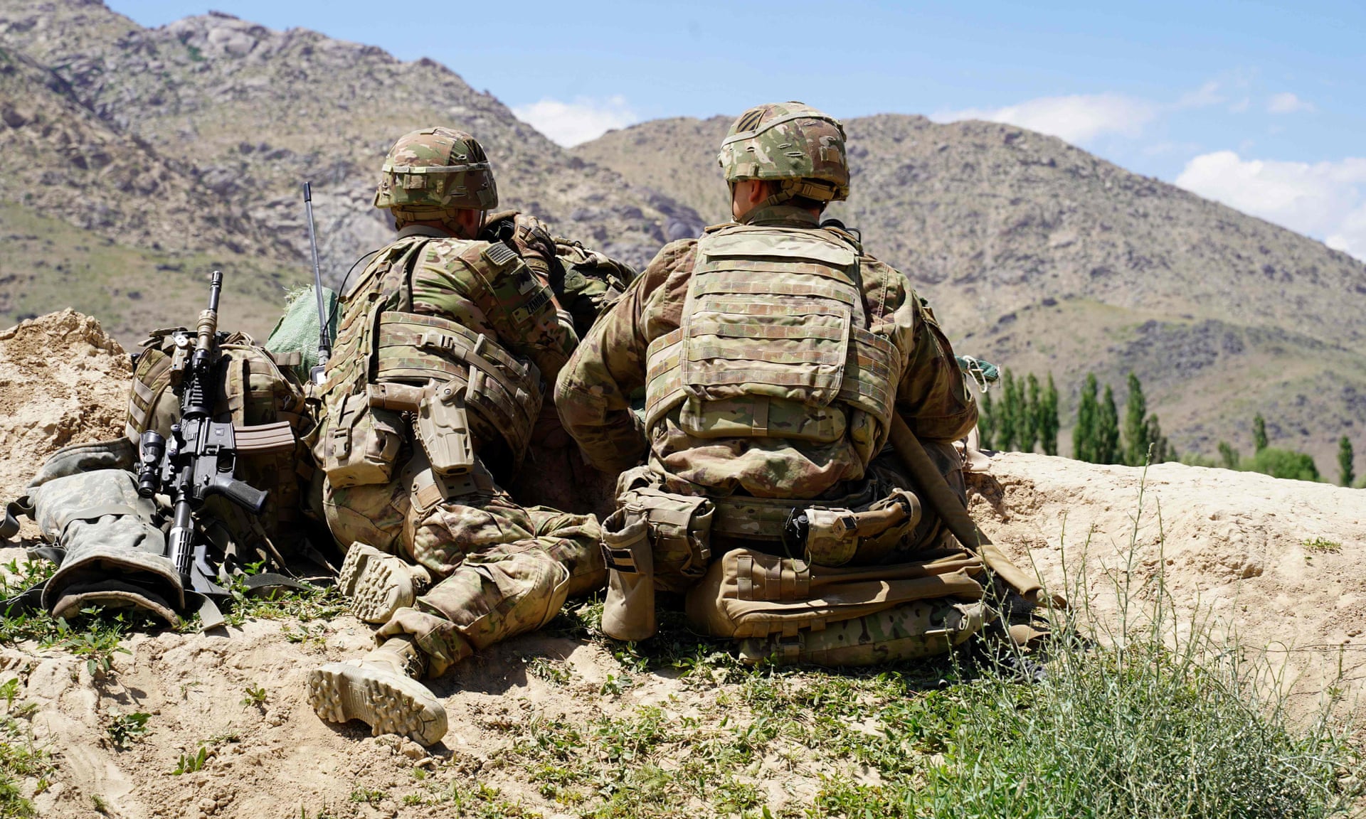 In this file photo taken on June 6, 2019 US soldiers look out over hillsides during a visit of the commander of US and NATO forces in Afghanistan General at the Afghan National Army (ANA) checkpoint in Nerkh district of Wardak province.