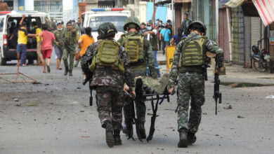 Military personnel carry an injured victim after the twin bombing in Philippines.