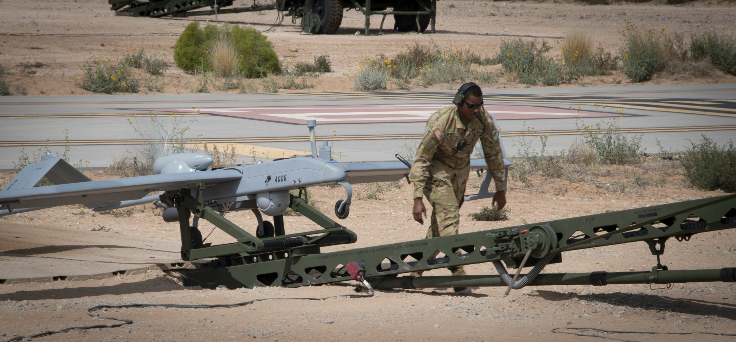 Photo of a Tactical Unmanned Aerial System maintainer with 3rd Squadron, 6th Cavalry Regiment, conducting final preflight checks during operational tests of the new RQ–7B Shadow Block III system at Fort Bliss, Texas