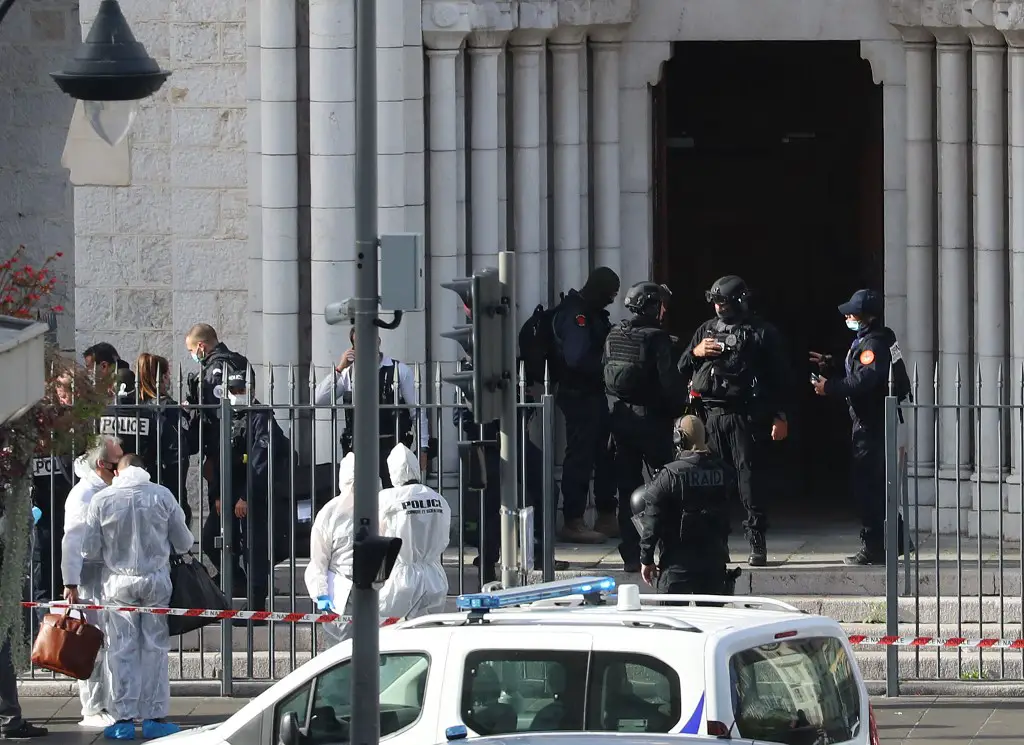 French members of the elite tactical police unit RAID enter to search the Basilica of Notre-Dame de Nice as forensics officers wait outside after a knife attack in Nice on October 29, 2020