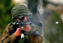 An Israeli soldier fires rubber bullets at Palestinian protesters during a weekly demonstration against the expropriation of Palestinian lands in the occupied West Bank, on February 1, 2019