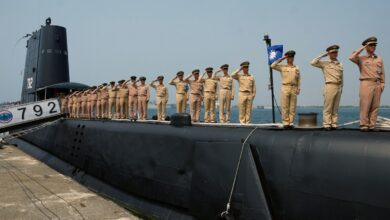Taiwanese navy staff salute from a US-made Guppy class submarine at the Tsoying navy base in southern Kaohsiung on September 30, 2014.