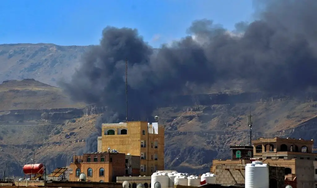Smoke billows following a reported airstrike by the Saudi-led coalition in the Yemeni capital Sanaa, on November 27, 2020