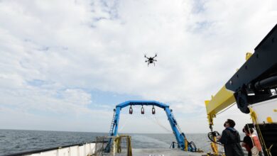 NSWC PHD Research Technology Applications Manager Alan Jaeger and Cybersecurity Researcher Ian Wilson test out the capabilities of a quadcopter drone at the stern of a ship on Friday, September 18.