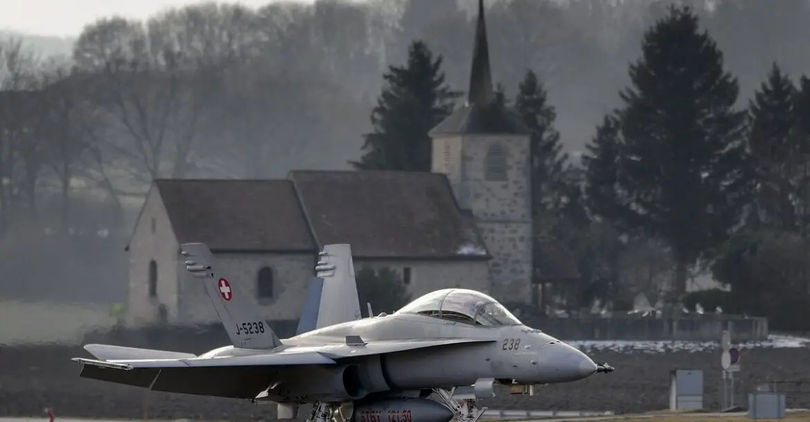 A Swiss Air Force F-18 is seen in front of a church on Feb. 20, 2013, at Payerne airport.
