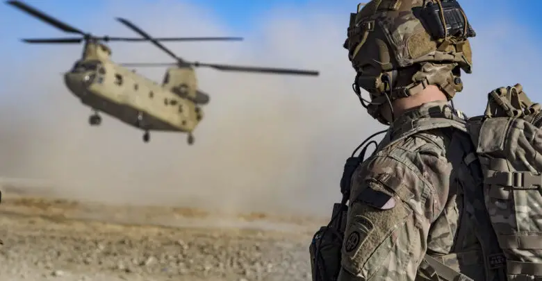 Army Staff Sgt. Jason N. Bobo watches as a CH-47 Chinook prepares to land to provide transport for US and Afghan soldiers after a key leader engagement in southeastern Afghanistan, December 29, 2019
