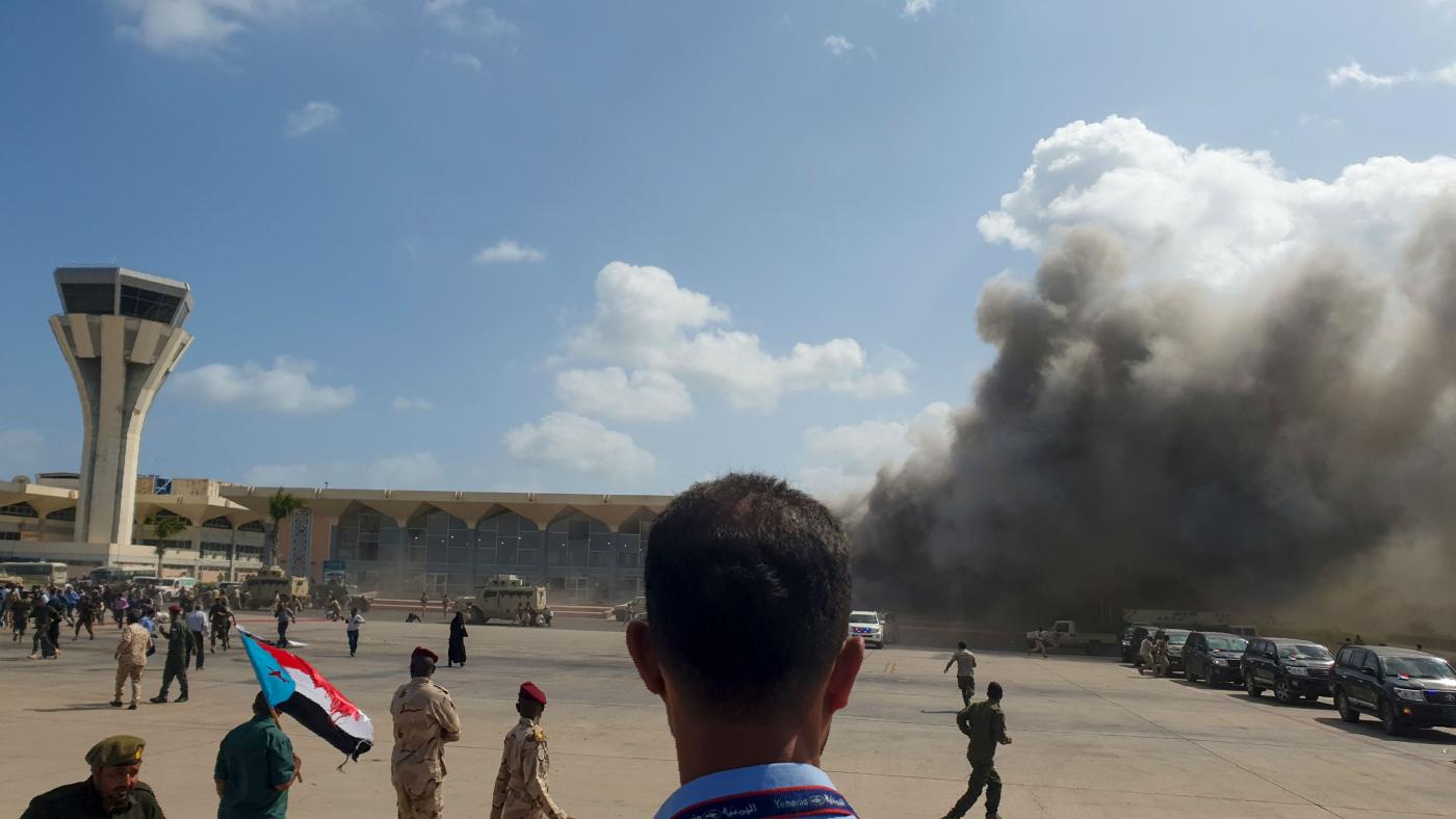Smoke billows from the airport building in Aden, Yemen.