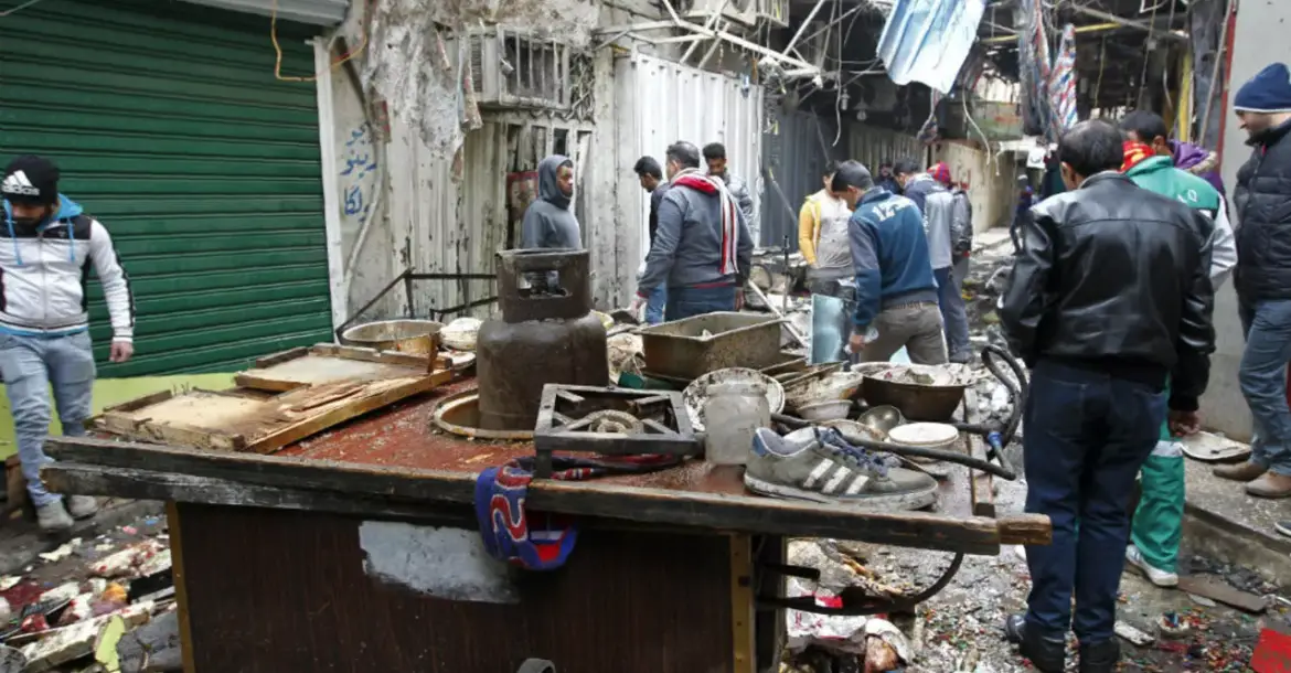 The aftermath of a double bomb attack in a busy market area in Baghdad's central al-Sinaq neighbourhood on December 31, 2016.